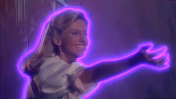 Kira (Olivia Newton-John) reaching forward with a bright purple neon glow around her