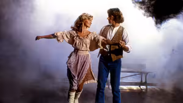 Kira (Olivia Newton-John) and Sonny Malone (Michael Beck) dancing together in a hazy room