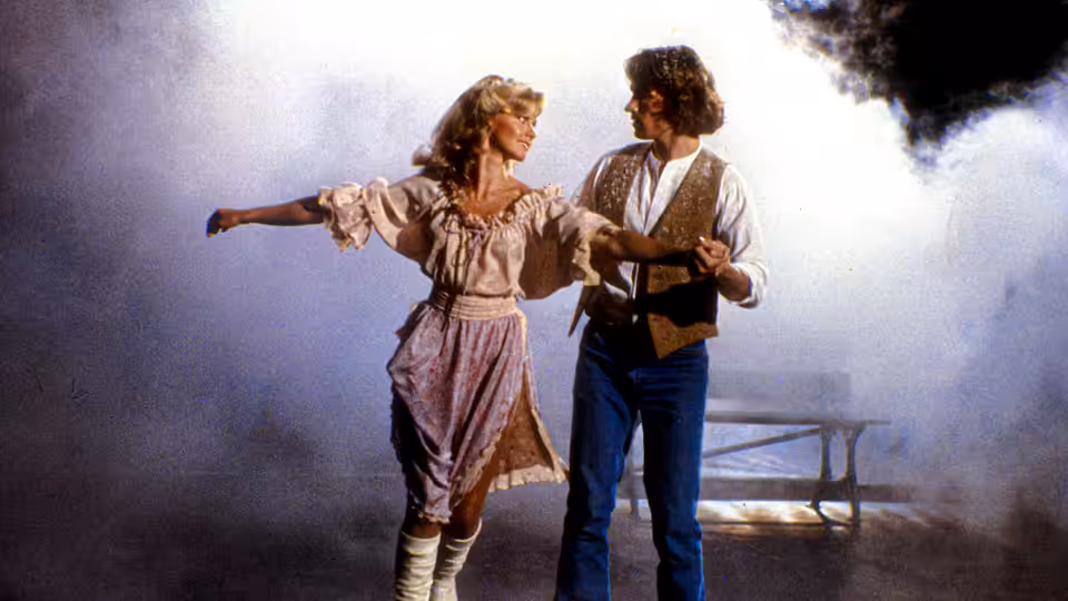Kira (Olivia Newton-John) and Sonny Malone (Michael Beck) dancing together in a hazy room