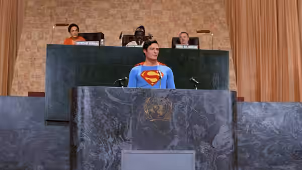 Superman (Christopher Reeve) stands at the United Nations podium addressing delegates