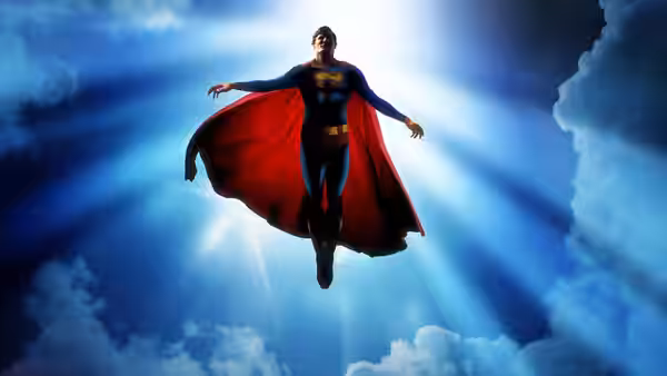 Superman (Christopher Reeve) flies through bright sunlit clouds with arms spread