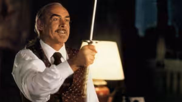Ramirez (Sean Connery) raising a sword in a dimly lit room
