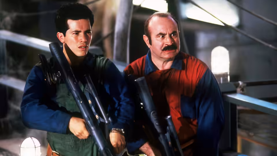 Mario and Luigi holding large weapons in an industrial corridor