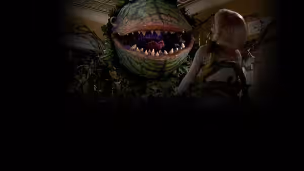 A woman looking at a giant plant creature with open jaws