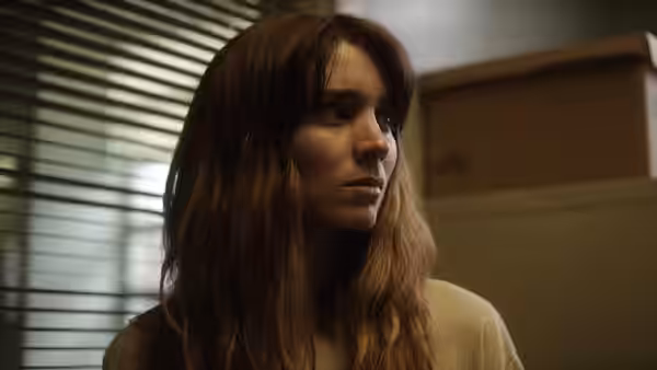 Emily Taylor (Rooney Mara) gazing to the side with a serious expression