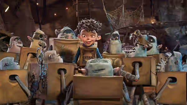 Eggs (Isaac Hempstead Wright) sits among boxtrolls in a crowded underground workshop