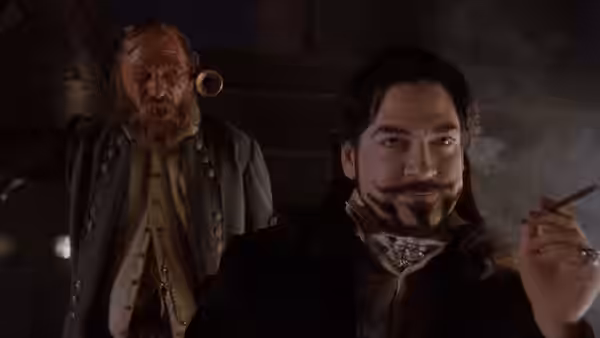 Dr. Arliss Loveless (Kenneth Branagh) holding a cigar with a bearded man nearby