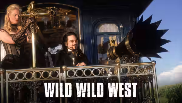 Rita Escobar (Salma Hayek) at controls beside Dr. Arliss Loveless on a vehicle