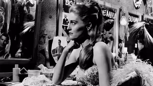 Cathy (Constance Towers) sits at a dressing table, gazing toward a mirror
