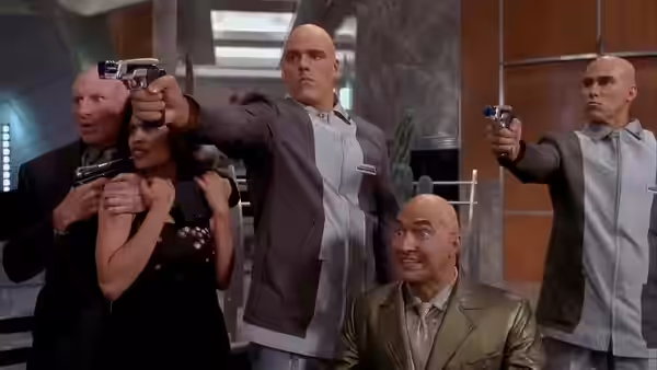 Group aims guns while standing in a sleek modern lobby