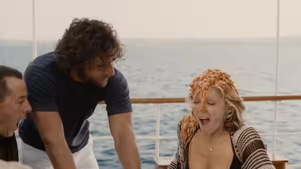 Amber Leighton (Madonna) with pasta on her head on a boat deck