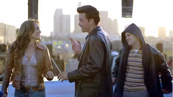 Ricki (Jennifer Lopez) smiling at Larry (Ben Affleck) gesturing on a rooftop with Brian (Justin Bartha)