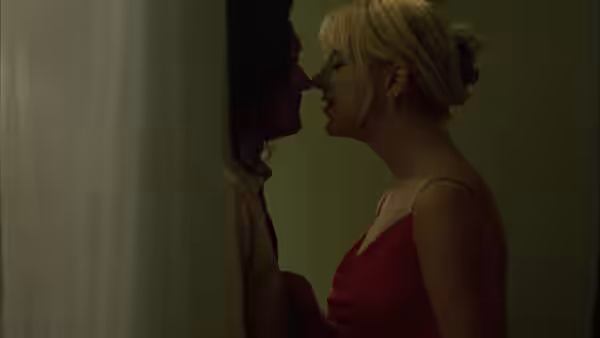 Johnny (Tommy Wiseau) and Lisa (Juliette Danielle) facing each other closely indoors