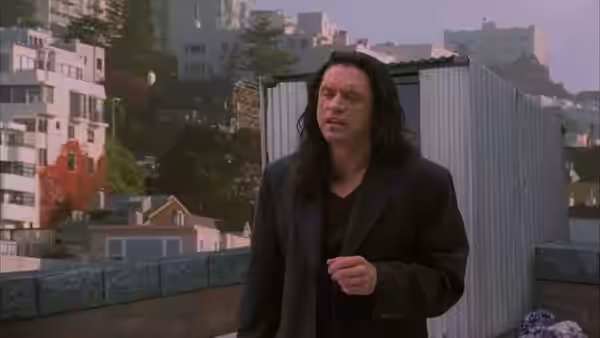 Johnny (Tommy Wiseau) standing on rooftop looking to the side