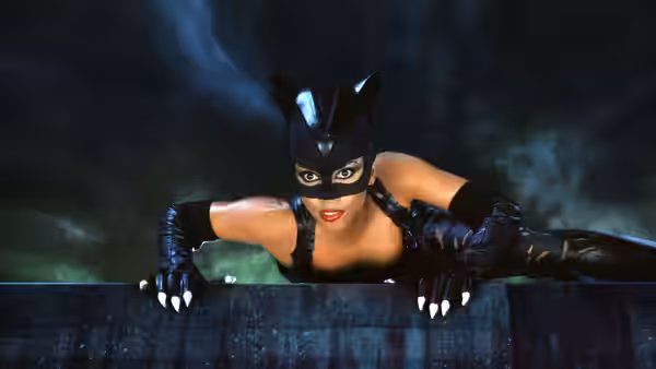 Catwoman (Halle Berry) perched on a rooftop ledge at night