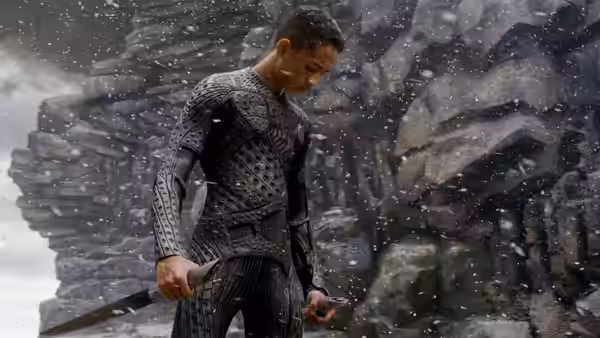 Kitai Raige (Jaden Smith) holding a blade in a snowy rocky canyon