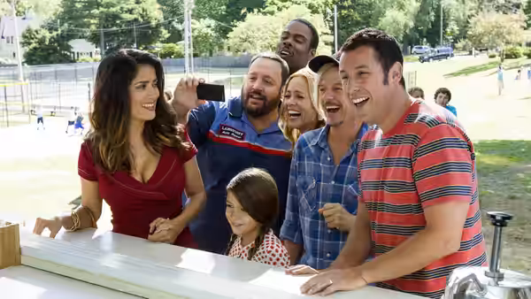 Roxanne Chase-Feder (Salma Hayek) stands with family at an outdoor concession stand