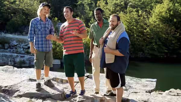 Lenny Feder (Adam Sandler) gestures to friends standing on rocks by a river