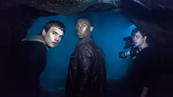 Matt Garetty, Steve Montgomery and Andrew Detmer explore a dark cave with a camera