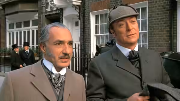 Dr. John Watson (Ben Kingsley) walks beside Sherlock Holmes (Michael Caine) outside a London house