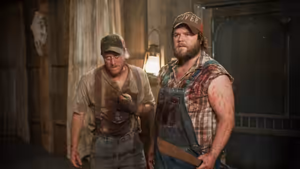Tucker (Alan Tudyk) and Dale (Tyler Labine) stand inside a wooden building covered in blood