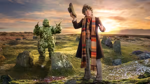 Tom Baker as the Doctor holding a shoe beside a green monster on moorland