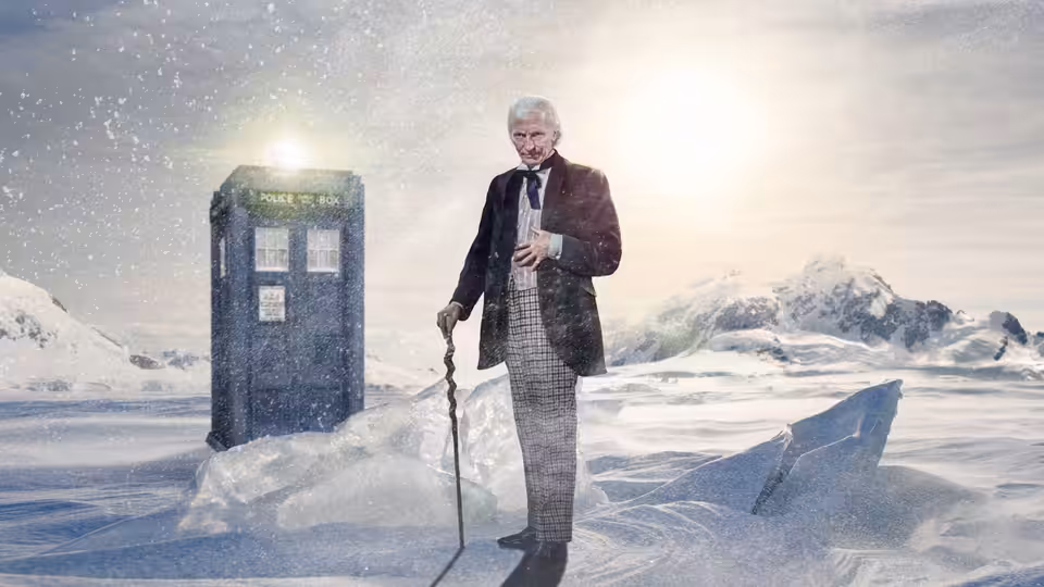William Hartnell as the Doctor standing with cane beside the TARDIS in snow