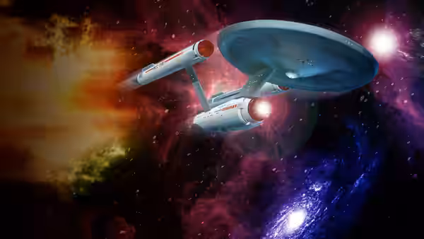Starship Enterprise flying through a colorful nebula with glowing engines