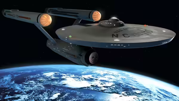 Starship Enterprise orbiting above a blue planet with white clouds