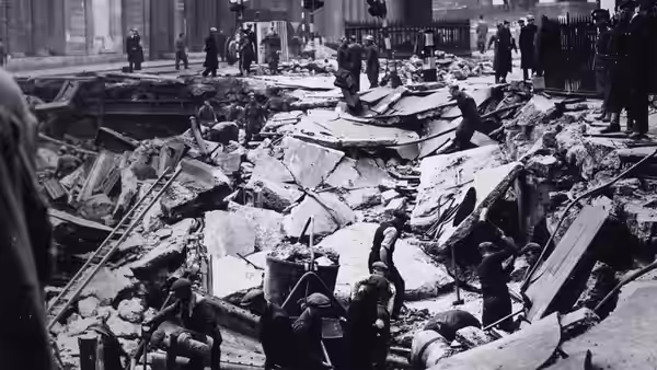 Civilians clearing rubble from a destroyed street after bombing