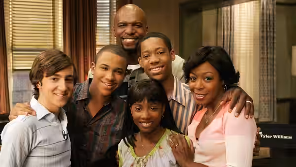 Smiling family posing closely together in a living room