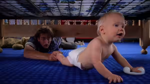 H.I. (Nicolas Cage) lies under the bed watching Nathan Junior crawl