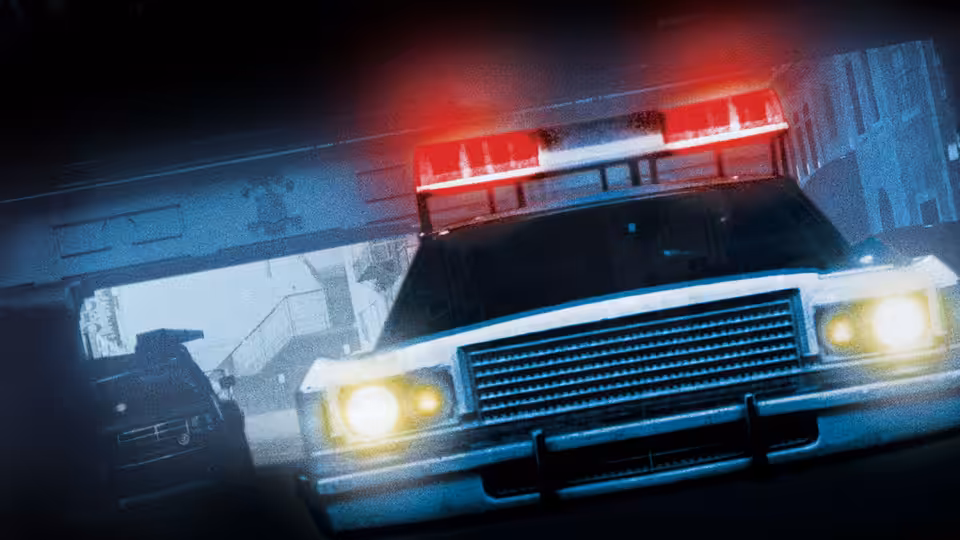 Police car with flashing red lights in a dark tunnel