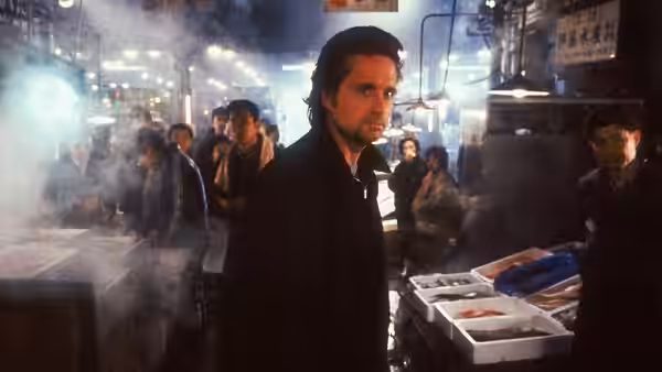 Nick Conklin (Michael Douglas) stands in a crowded, smoky Osaka market
