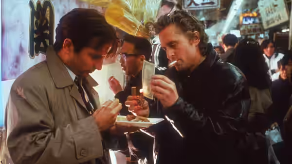 Nick Conklin (Michael Douglas) and Masahiro (Ken Takakura) eat at a crowded street stall