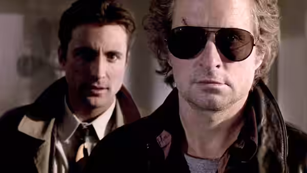 Nick Conklin (Michael Douglas) wears sunglasses as Charlie Vincent (Andy Garcia) stands behind him