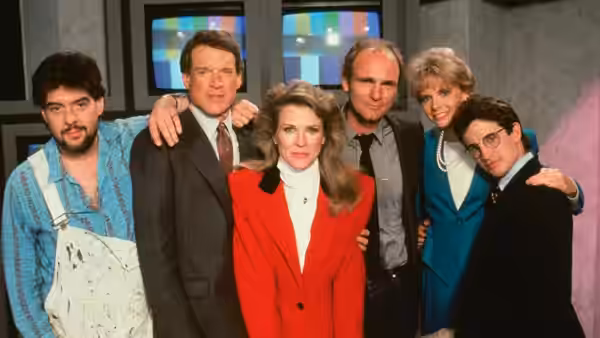 Murphy Brown (Candice Bergen) poses with Eldin Bernecky and her colleagues