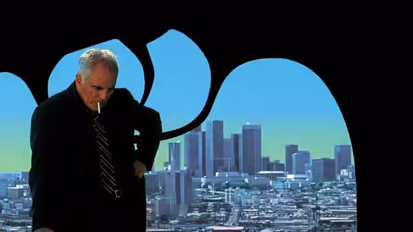 Wilson (Terence Stamp) smoking before a city skyline at a window