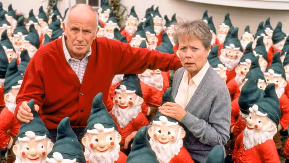 Victor Meldrew (Richard Wilson) and Margaret Meldrew (Annette Crosbie) stand among rows of garden gnomes