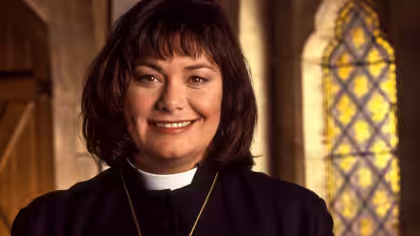 Revd Geraldine Granger (Dawn French) smiling warmly inside a church