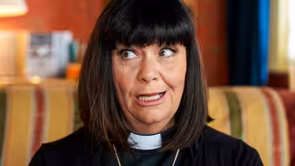 Revd Geraldine Granger (Dawn French) looking surprised while seated indoors