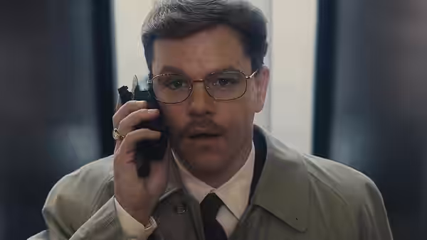 Mark Whitacre (Matt Damon) speaking on a cell phone in a trench coat