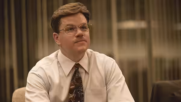 Mark Whitacre (Matt Damon) seated in a white shirt looking to his left
