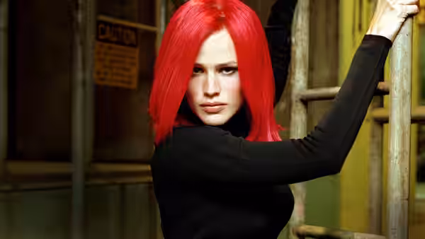 Red-haired woman in black top grips a metal railing and glances back