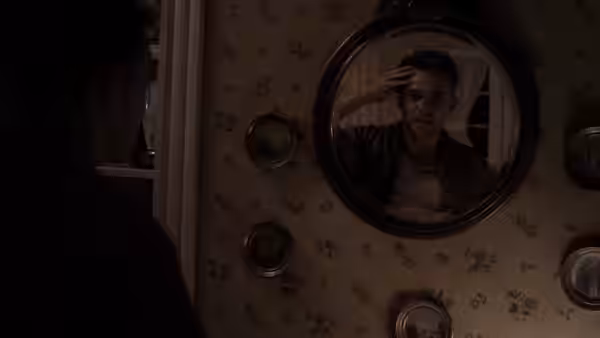 Ben Hawkins (Nick Stahl) reflected in a mirror touching his forehead
