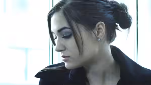 Chelsea (Sasha Grey) in profile looking down beside a bright window
