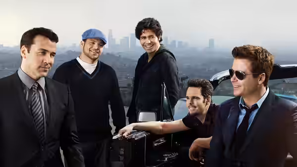 Five men posing with a briefcase beside a convertible overlooking the city