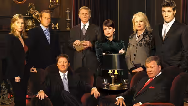 Business team posing in an elegant office with red armchairs