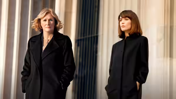 Patty Hewes (Glenn Close) and Ellen Parsons (Rose Byrne) outside a building