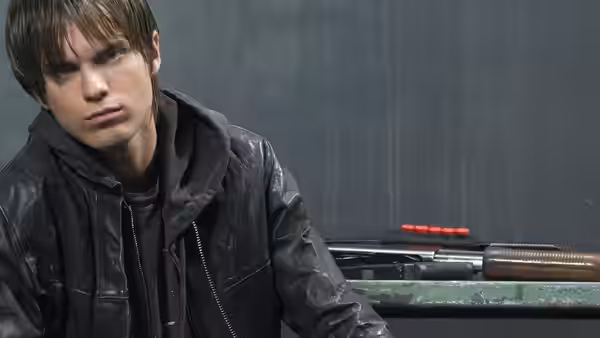 John Connor seated beside a shotgun on a green table